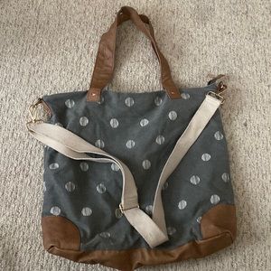 Big polka dot tote bag with crossbody strap.
